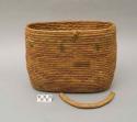 Oblong utility basket, coiled. Broken handle. Made of bear grass.