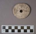 Perforated ground stone disk