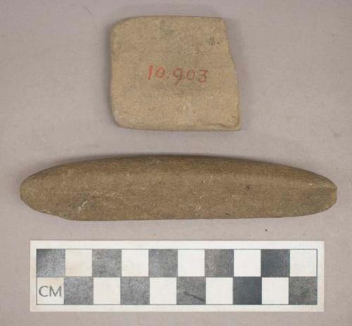 Ground stone, abraiding stone and sharpening stone fragment with grooved center