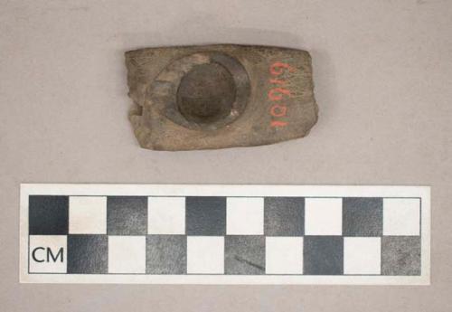 Ground stone, platform pipe fragment, incised decoration