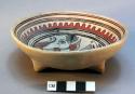Ceramic tripod bowl with geometric design on interior