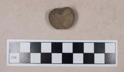 Ground stone, notched, possible weight