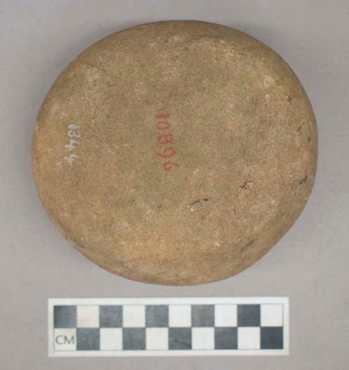 Ground stone, grinding stone, pitted on one side