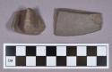 Ground stone, fragments; one possible bannerstone fragment and one edged fragment