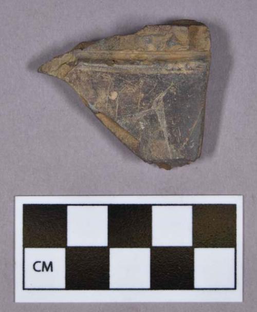 Ground stone, fragment, burnished and incised