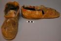 Pair of man's moccasins--deerskin w/ rawhide sole; quilled floral pattern on toe