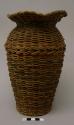 Urn-shaped basket, plaited over glass jar
