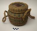 Deep sewing basket of ash splints and braided sweetgrass, with "frog" handle on lid