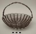 Coiled wire basket with braided handle