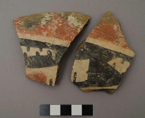 Body sherd from jar. The exterior is decorated in an anthropomorphic red, black & white design. tonto polychrome.