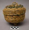 Basket with three feet, curly splintwork on cover