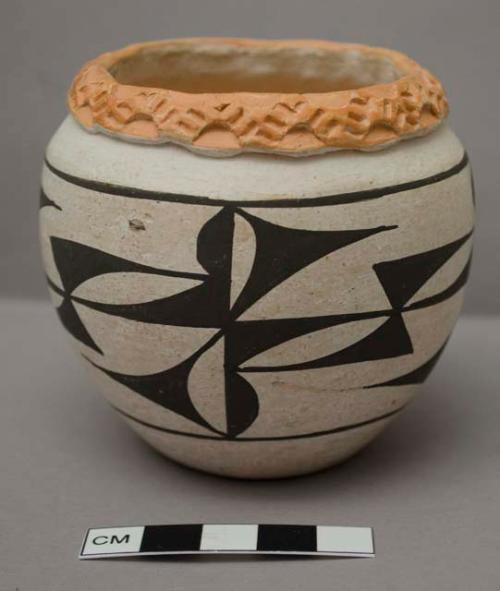 Small pot with black design, orange rim