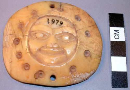 Round ivory pendant, human face