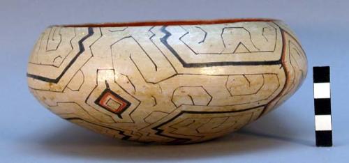 Ceramic bowl, exterior white slip, lattice type geometric patterns, interior red