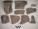 Ceramic, earthenware body, rim and handle sherds, some incised designs, some with Ramey design, one with cord impressed decoration, one with incised rim, shell tempered; two rim and two body sherds crossmend