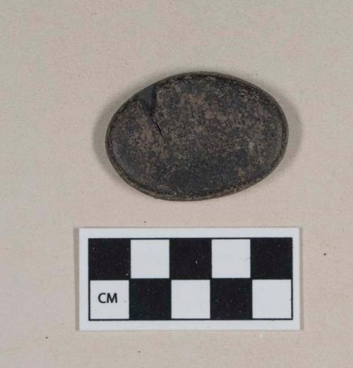 Worked cannel coal, flat ovoid object; two fragments crossmended with glue