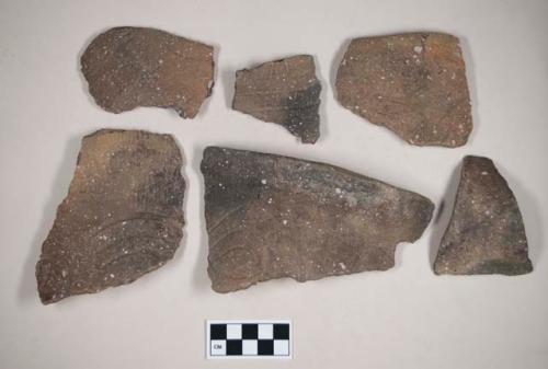 Ceramic, earthenware body, rim, and handle sherds, some incised, some incised and cord-impressed, some undecorated, shell-tempered; some with Ramie design