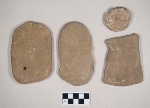 Stones and stone fragments, possibly ground or chipped, some possibly incised