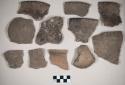 Ceramic, earthenware body, rim, and handle sherds, incised, one punctate, some with dentate rim, some with incised rim, one with incised and punctate rim, some possibly impressed, shell-tempered; two sherds crossmend