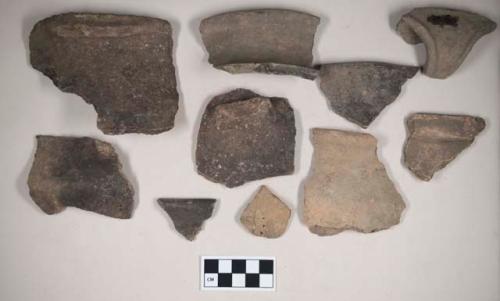 Ceramic, earthenware body, rim, and handle sherds, undecorated, one cord-impressed, one incised, one incised and punctate, one with perforated hole; shell-tempered