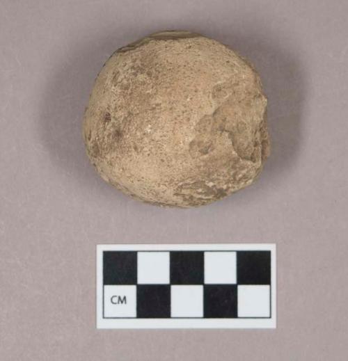 Ground stone, round stone object, possibly flaked or worn