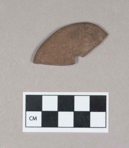 Ground stone, perforated stone fragment