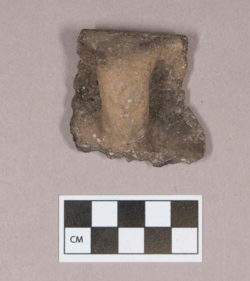 Ceramic, earthenware rim and handle sherd, undecorated, shell-tempered, with one perforated hole, possible mend hole