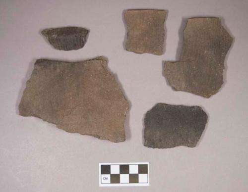 Ceramic, earthenware body and rim sherds, cord-impressed, grit-tempered; two sherds crossmend