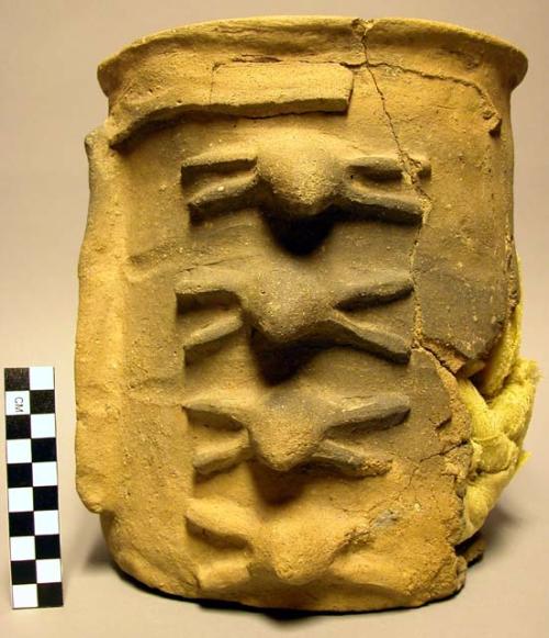 Complete ceramic jar, molded decoration, mended, sherds missing, lid.