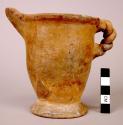 Small pitcher of buff ware, twisted handle