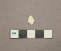 Undecorated white pearlware vessel fragment, white paste