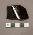 Amber glass vessel body fragment, likely bottle glass