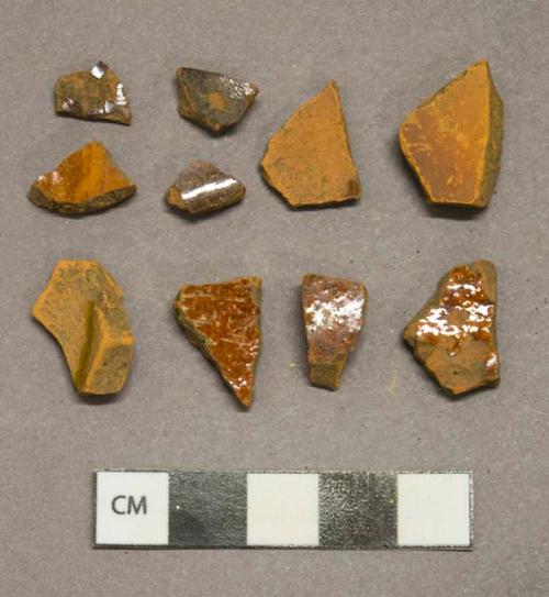 Mottled reddish brown lead glazed redware vessel body fragments