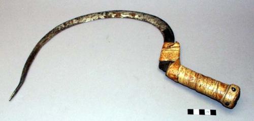 Iron sickle with birchbark wrapped wooden handle
