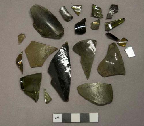 Olive green glass vessel fragments, likely bottle glass