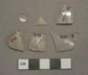 Colorless glass fragments, 1 with etched decoration, 2 stemware base fragments