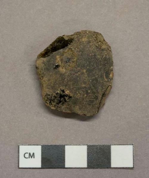 Dark olive glass vessel fragment, weathered