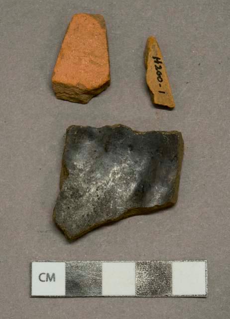 Redware vessel body fragments, 1 with black lead glaze on interior