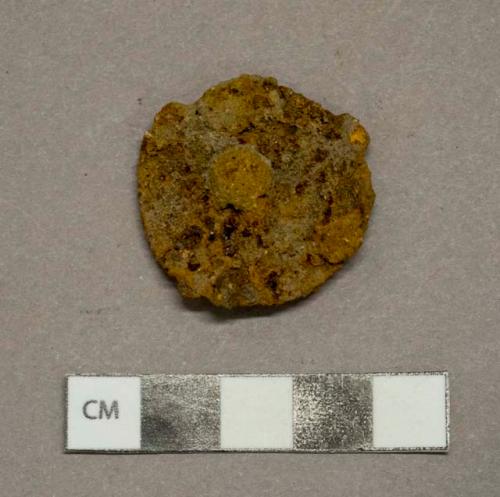 Ferrous metal button fragment, heavily corroded