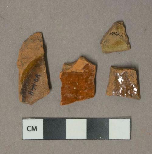 Reddish brown lead glazed redware vessel body and base fragments