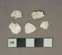 White shell fragments, heavily degraded