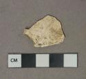 Undecorated white pearlware vessel body fragment, most glaze missing, white paste