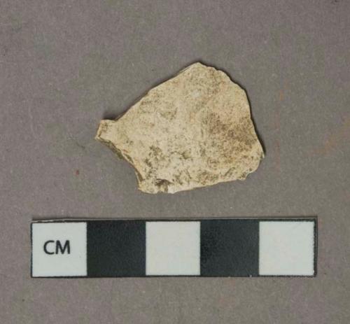 Undecorated white pearlware vessel body fragment, most glaze missing, white paste