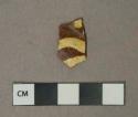 Yellow on brown slip decorated redware vessel body fragment