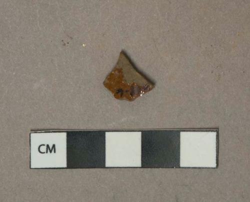 Reddish brown lead glazed redware vessel body fragment, grayish red paste