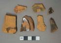 Brown lead glazed redware vessel body and base fragments