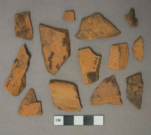 Brown lead glazed redware vessel body and rim fragments