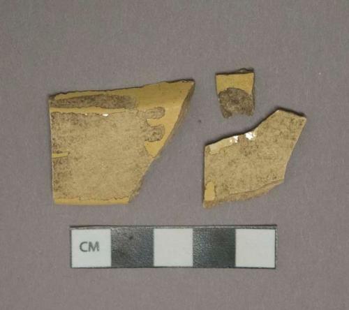 Yellow lead glazed earthenware vessel body fragment, buff paste, possibly mocha type