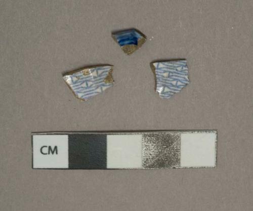Blue on white transferprinted whiteware vessel body and rim fragments, white paste