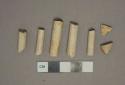 White undecorated kaolin pipe stem and bowl fragments, 4 stem fragments with 5/64" bore diameter, 1 with 6/64" bore diameter